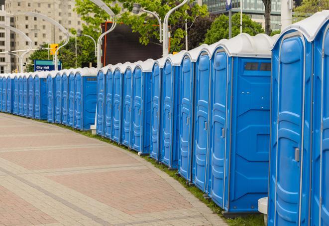 a row of portable restrooms at an outdoor special event, ready for use in Chandler